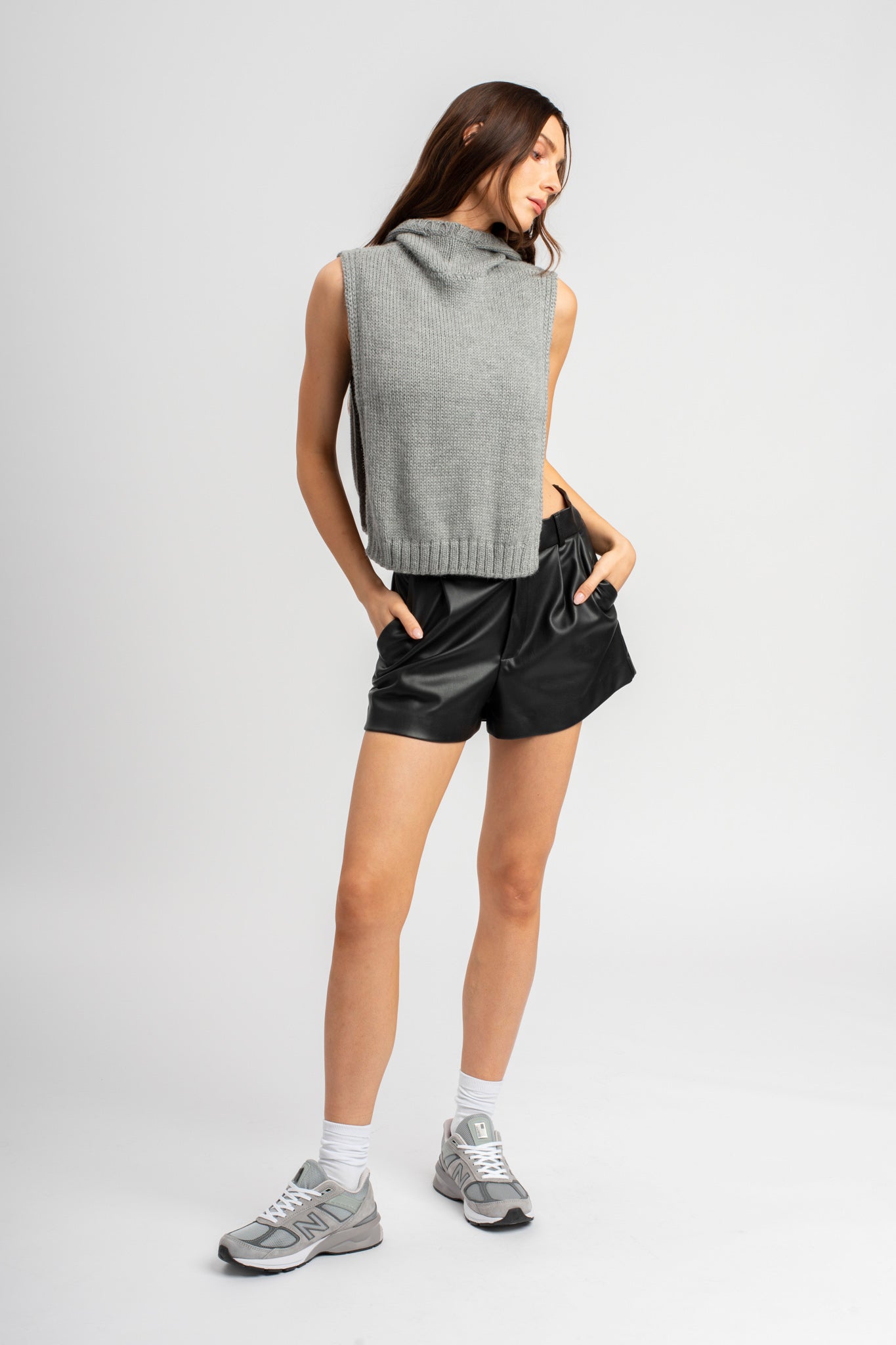 Model wearing poncho in light grey alpaca wool, front standing view