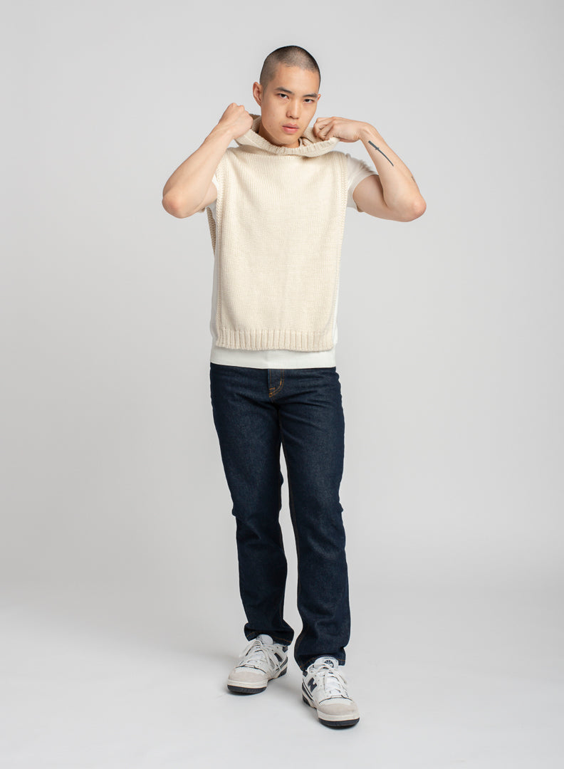 Model wearing poncho in white alpaca wool, front standing