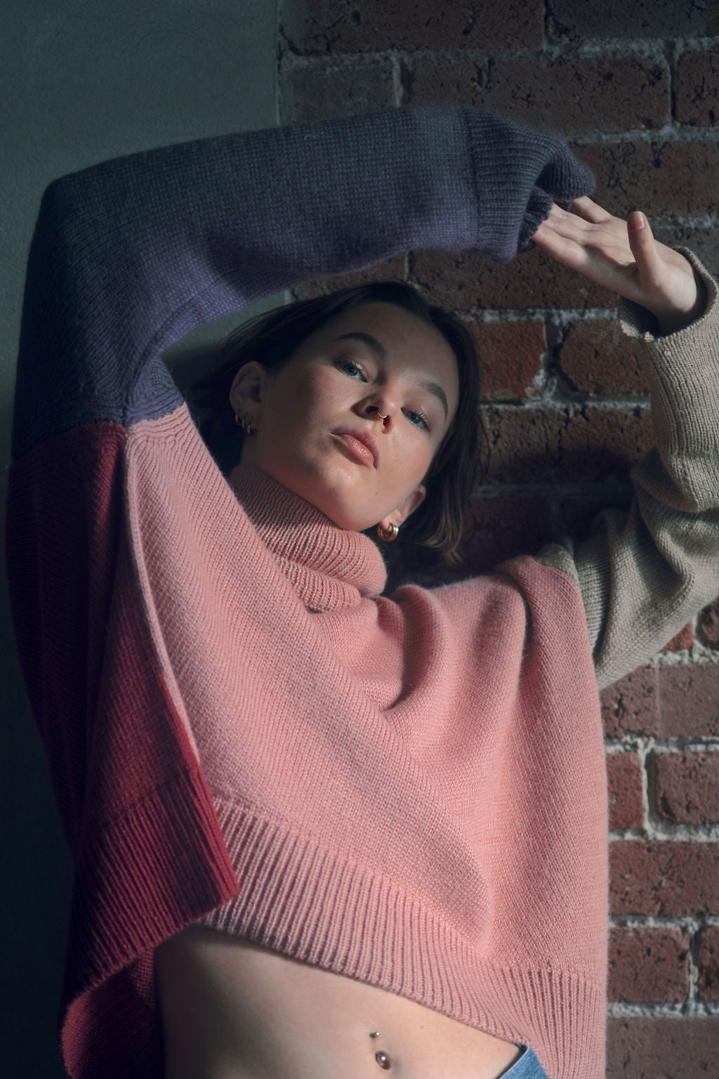 Model wearing oversized sweater in multi-color pink alpaca wool, front