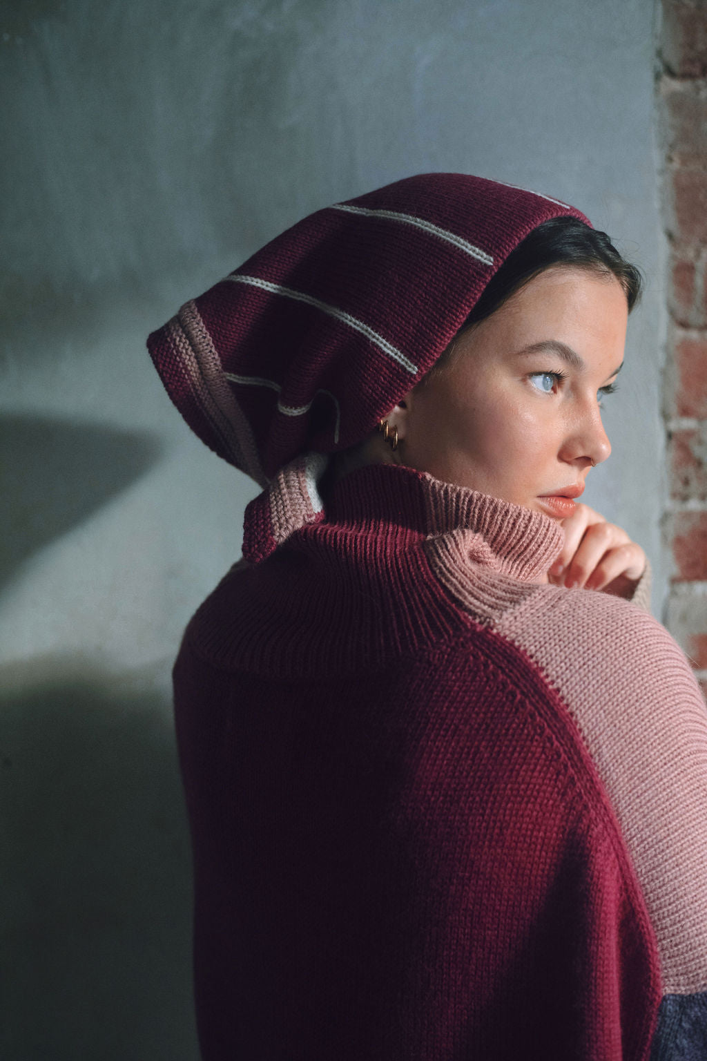 Model wearing oversized sweater in multi-color pink alpaca wool, side close-up