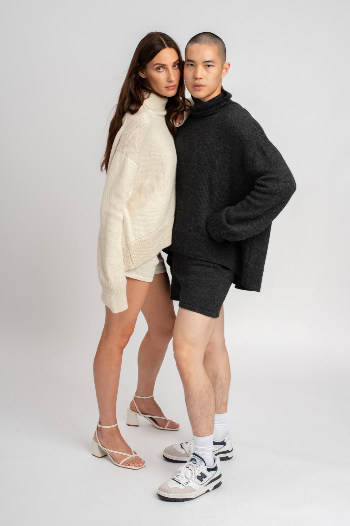 Model wearing turtleneck oversized sweater in white alpaca wool, side