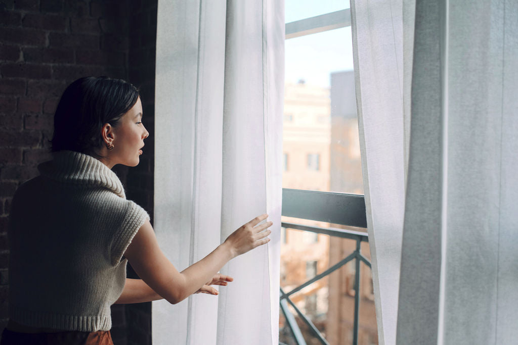 Model wearing white sweater crop top in alpaca wool, side distance
