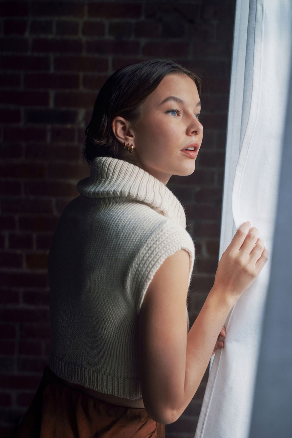 Model wearing white sweater crop top in alpaca wool, side