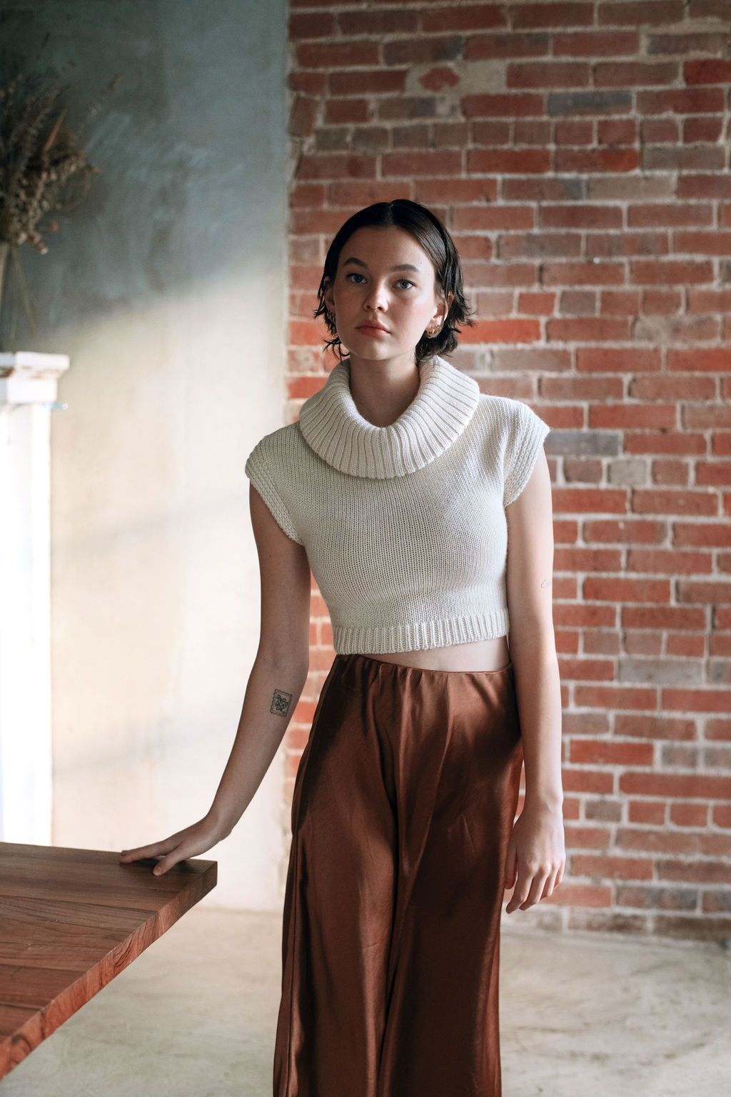 Model wearing white sweater crop top in alpaca wool, front standing