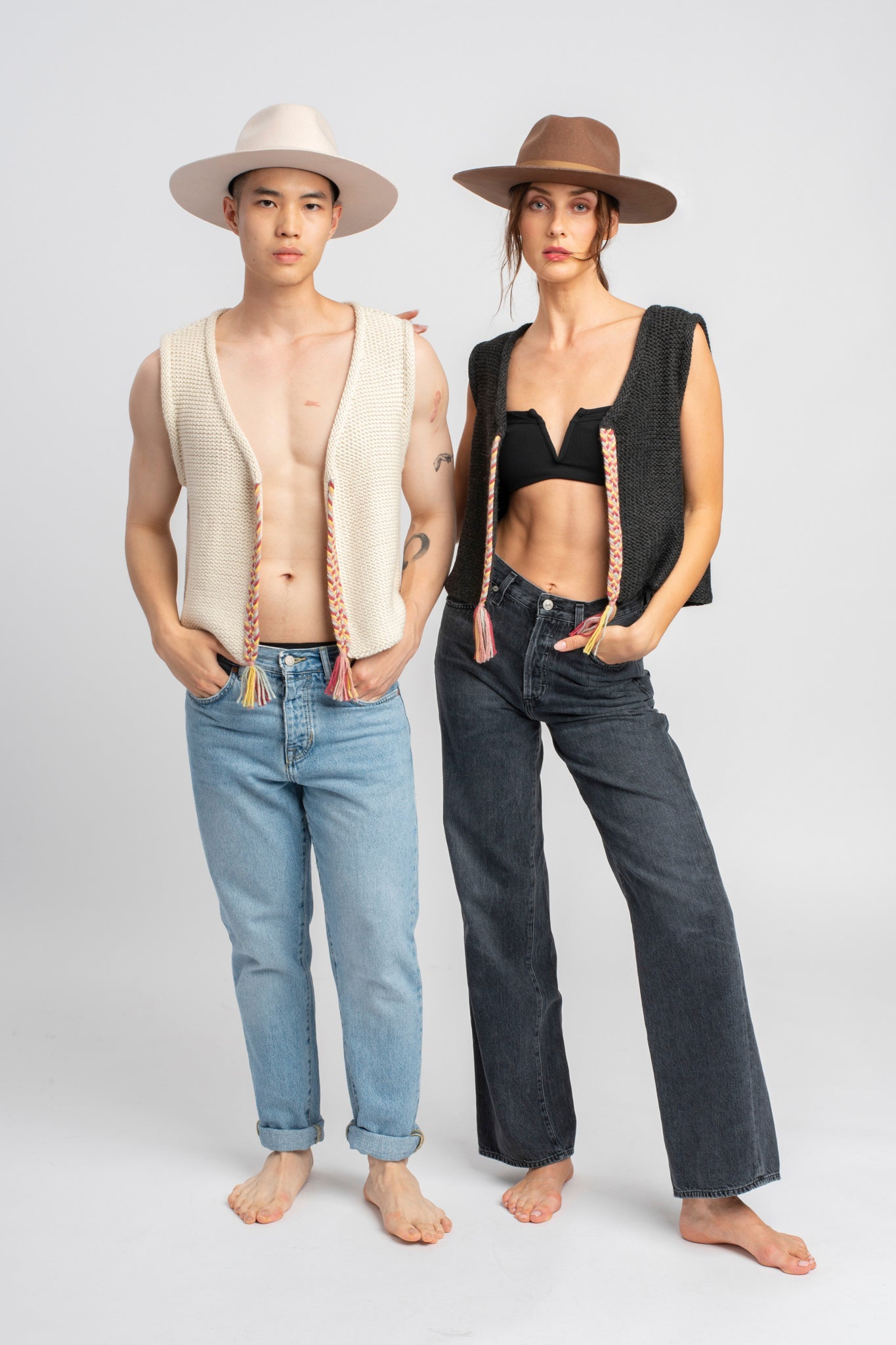 Two models wearing white sweater knit vests in alpaca wool, standing