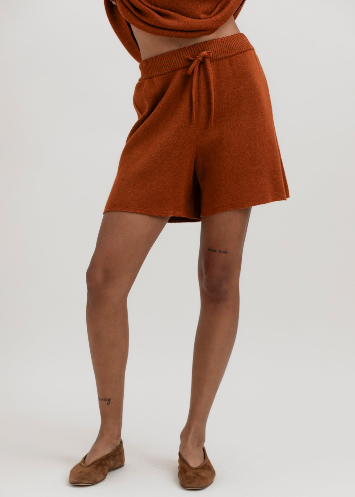 Airy Shorts in Burnt Orange, alpaca and silk knit shorts by Ahblo, worn by model