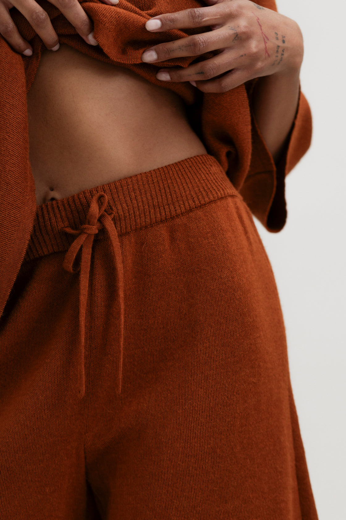 Airy Shorts in Burnt Orange, alpaca and silk knit shorts by Ahblo, worn by model