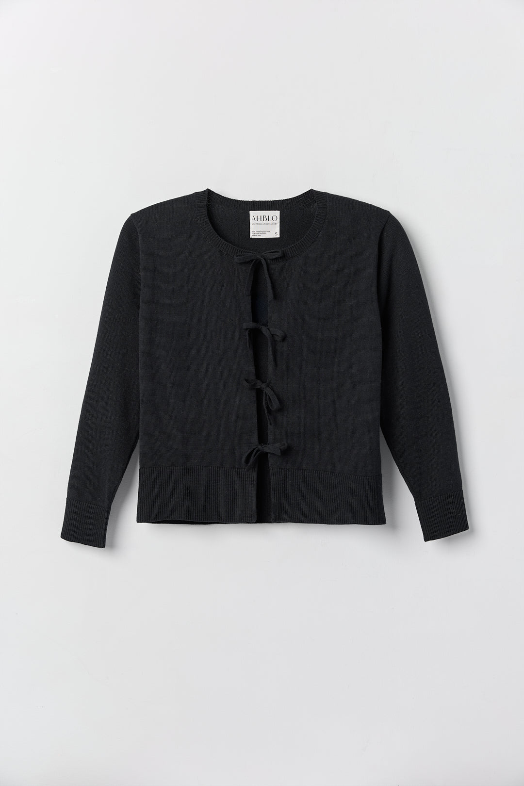 Amaya Cardigan in Black, cotton and baby alpaca bow cardigan by Ahblo, flat lay