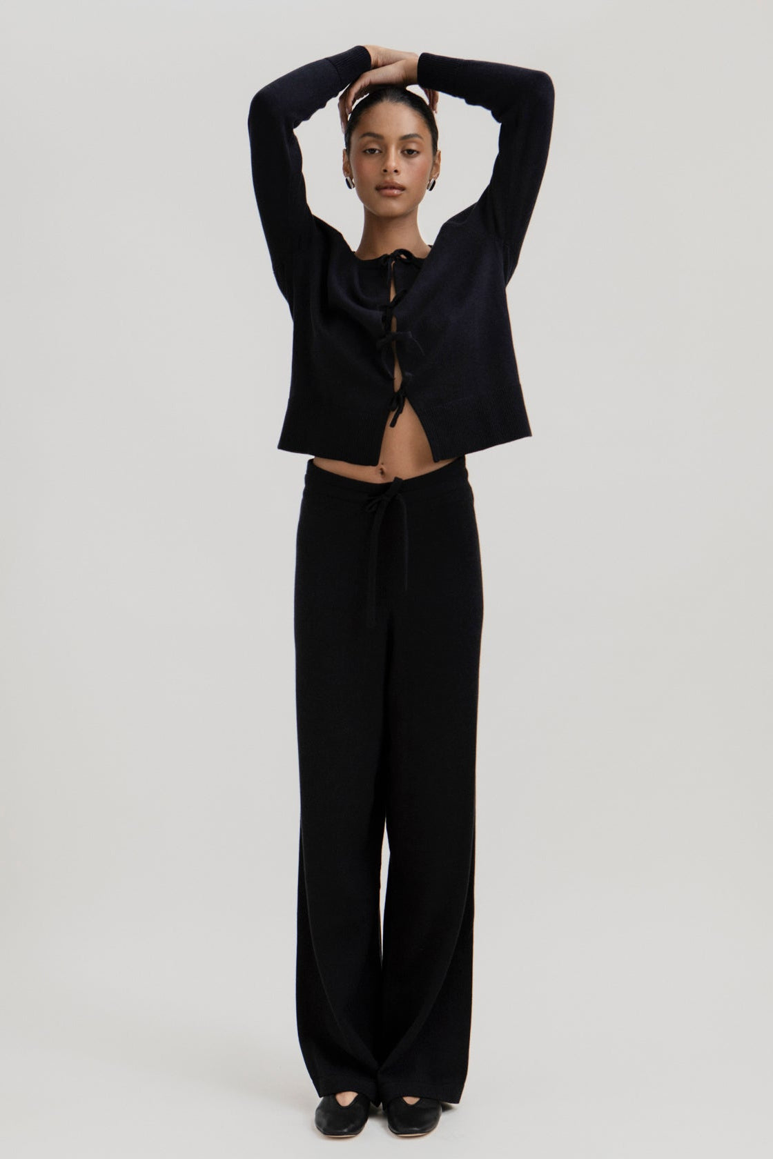 Amaya Cardigan in Black, cotton and baby alpaca bow cardigan by Ahblo, worn by model