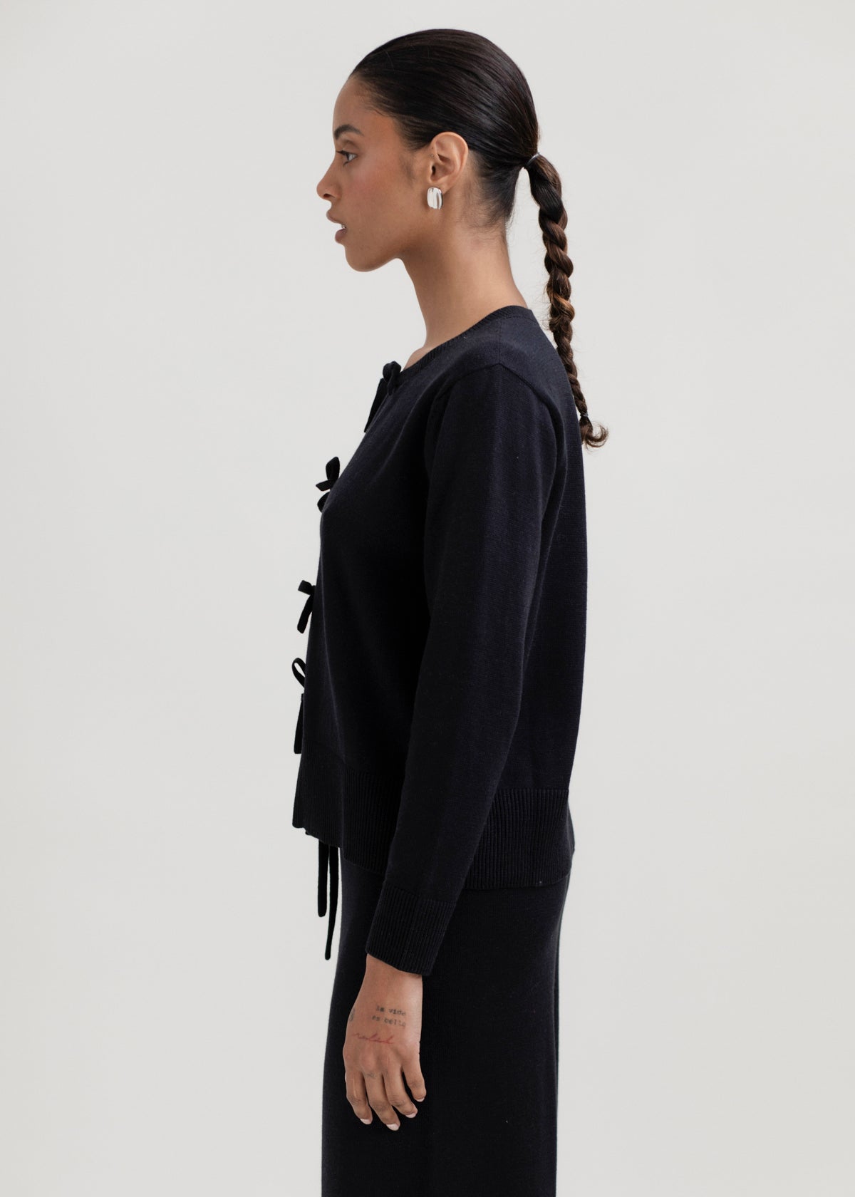 Amaya Cardigan in Black, cotton and baby alpaca bow cardigan by Ahblo, worn by model