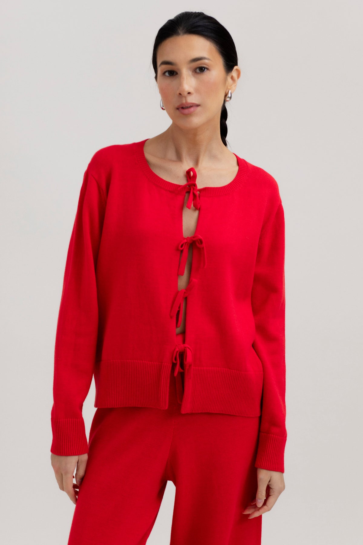 Amaya Cardigan in Cerise, cotton and baby alpaca bow cardigan by Ahblo, worn by model