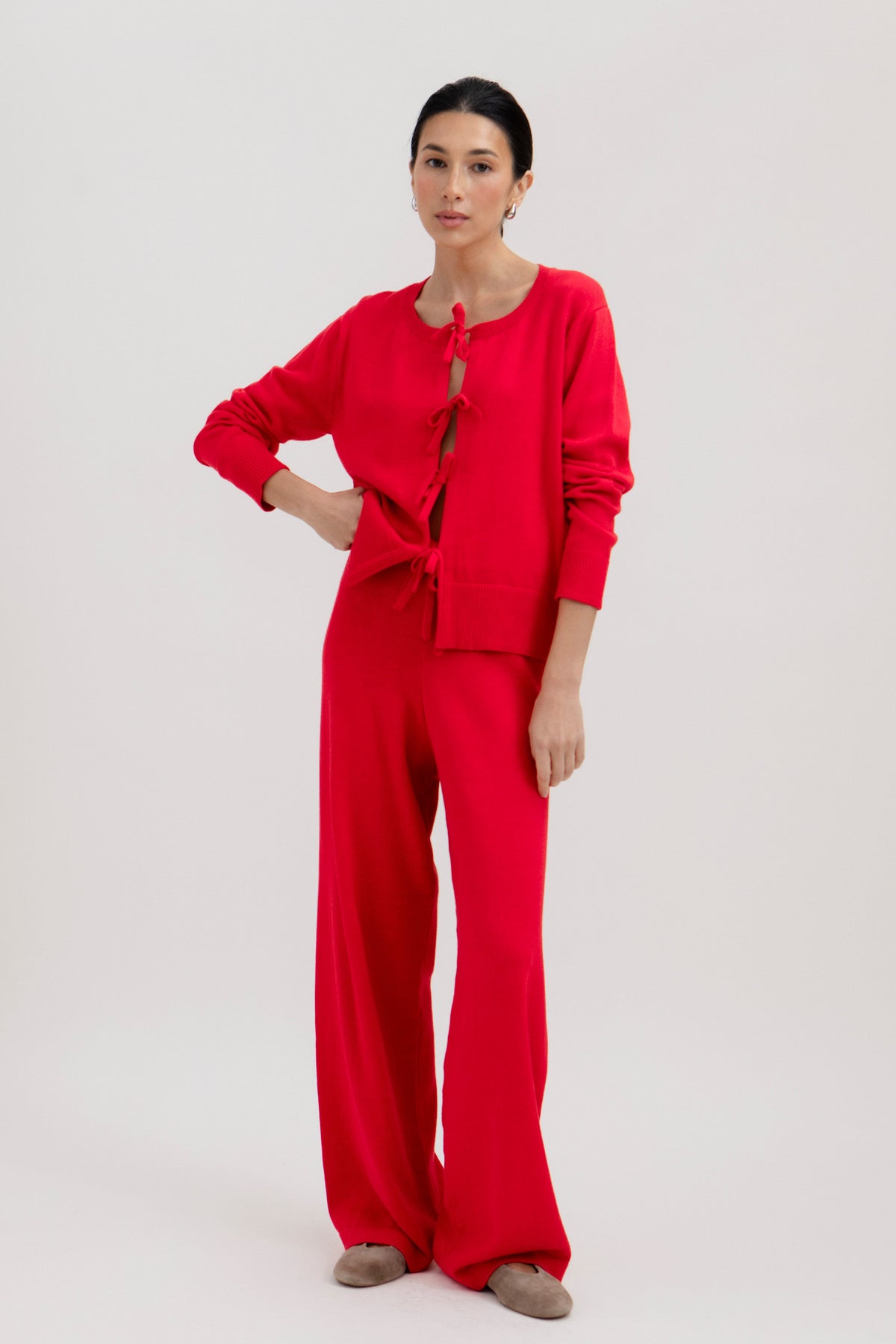 Amaya Cardigan in Cerise, cotton and baby alpaca bow cardigan by Ahblo, worn by model