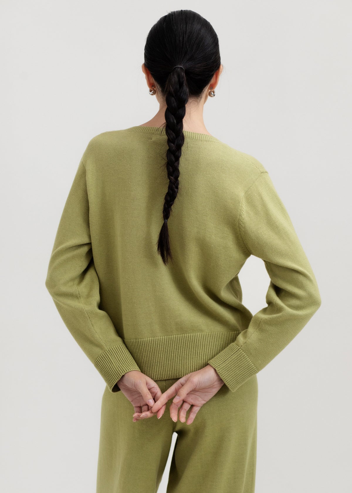 Amaya Cardigan in Olive, cotton and baby alpaca bow cardigan by Ahblo, worn by model