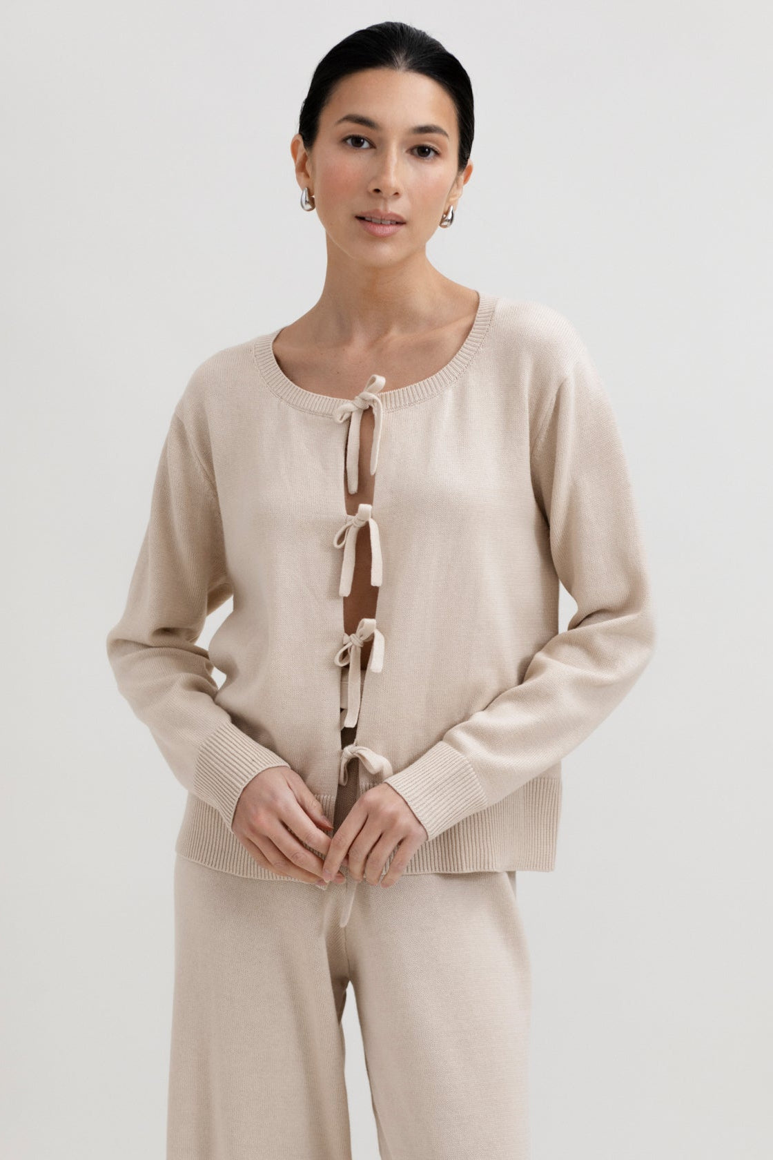 Amaya Cardigan in Praline, cotton and baby alpaca bow cardigan by Ahblo, worn by model