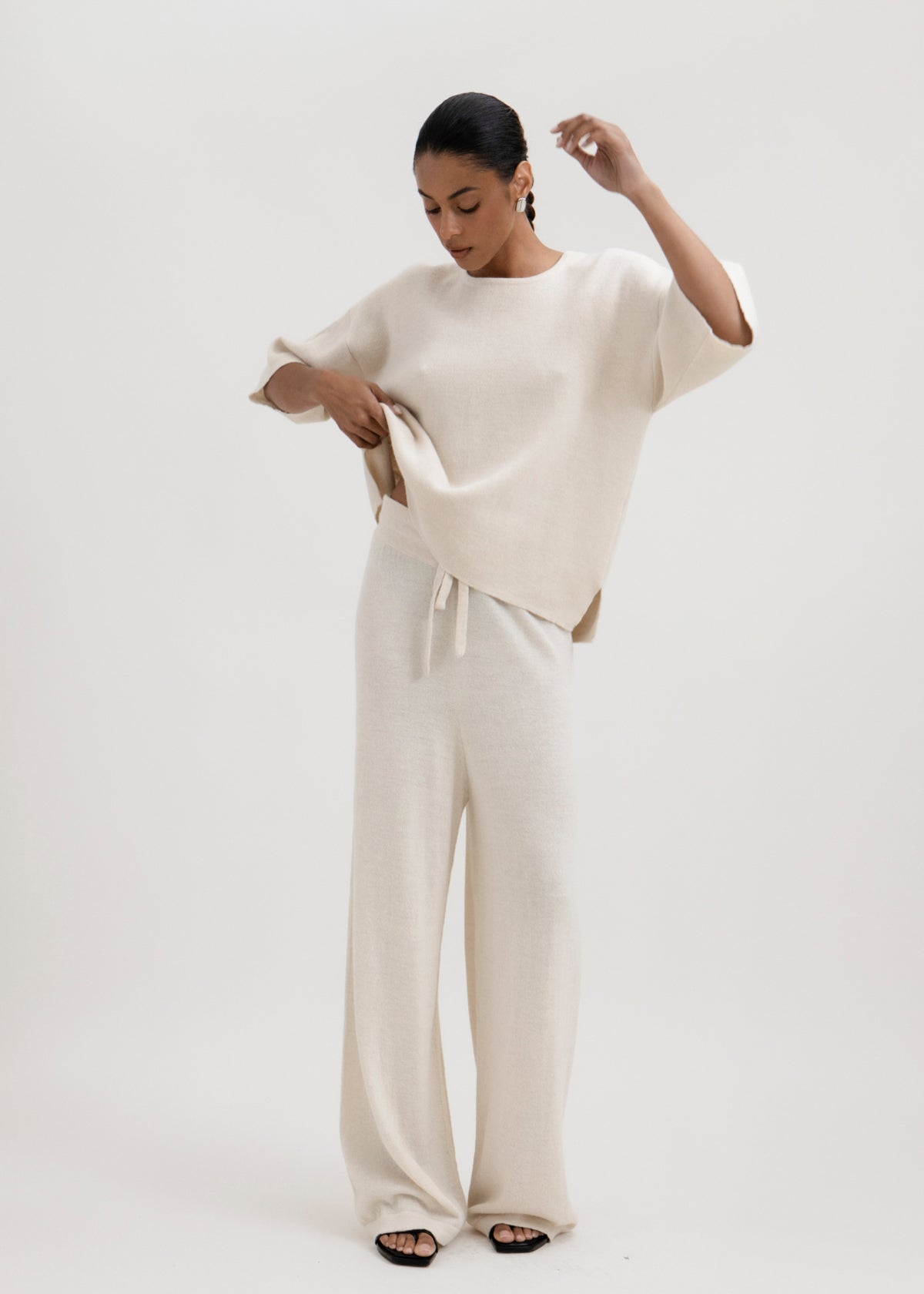 Avery Trousers in Cream, baby alpaca wide-leg knit trousers by Ahblo, worn by model
