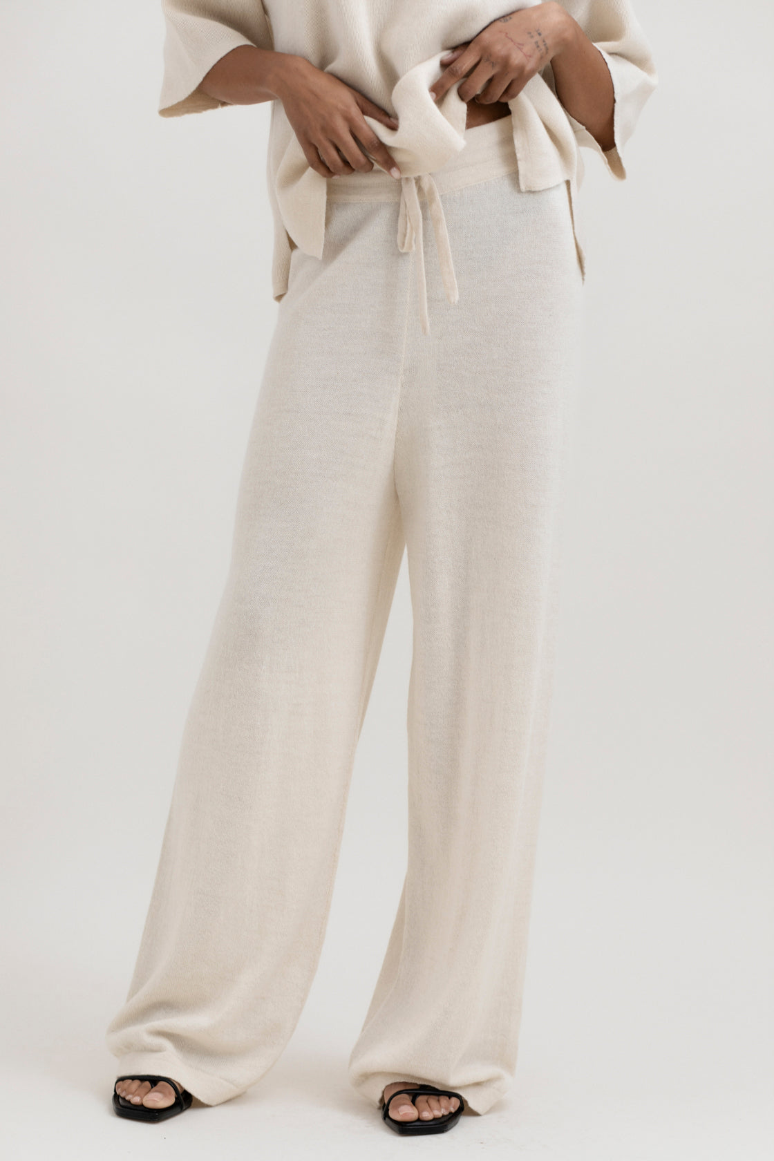 Avery Trousers in Cream, baby alpaca wide-leg knit trousers by Ahblo, worn by model