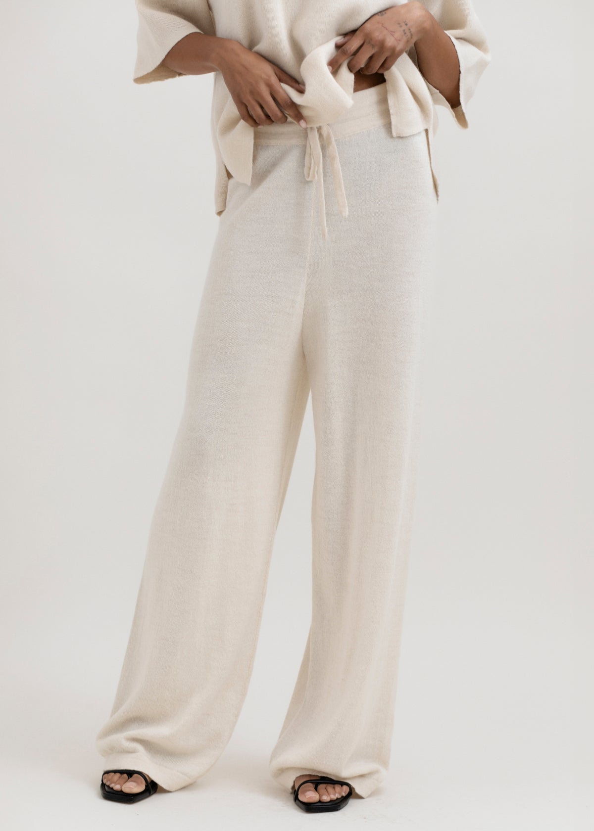 Avery Trousers in Cream, baby alpaca wide-leg knit trousers by Ahblo, worn by model