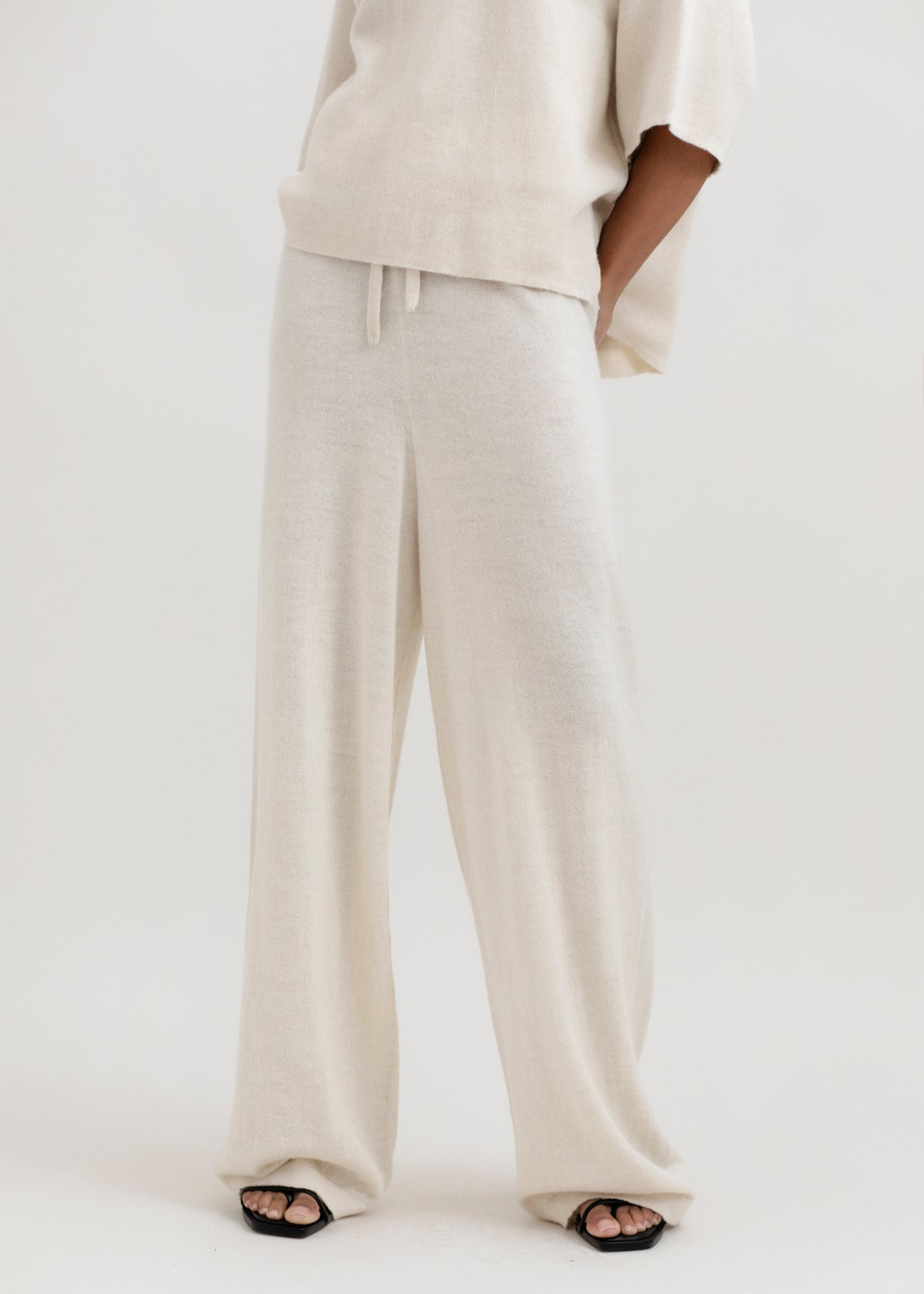 Avery Trousers in Cream, baby alpaca wide-leg knit trousers by Ahblo, worn by model