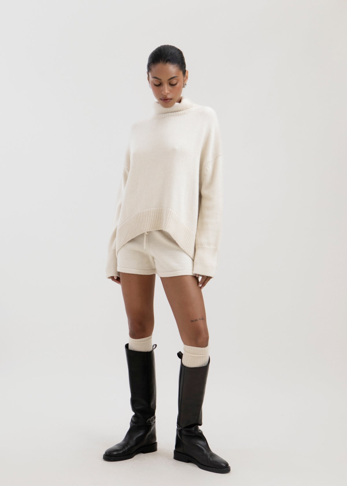Cove Shorts in Cream, baby alpaca knit shorts by Ahblo, worn by model