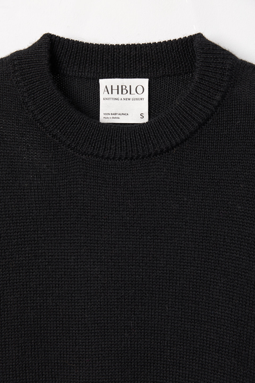 Haven Crew in Black, baby alpaca crew-neck sweater by Ahblo, flat lay