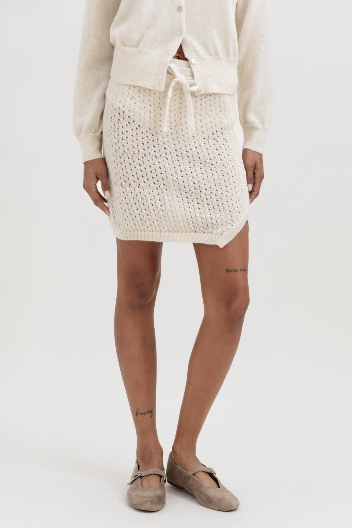 Lani Mini Skirt in Cream, baby alpaca knit mini skirt by Ahblo, worn by model