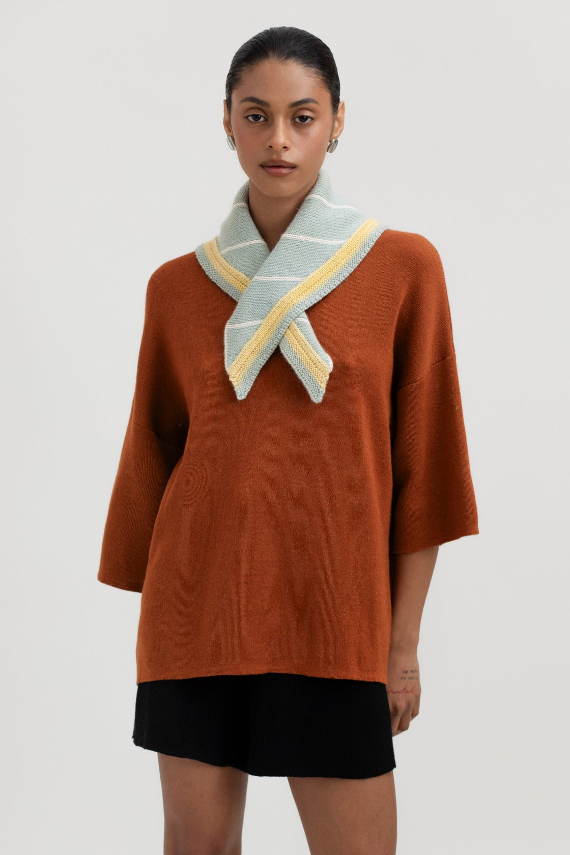 Lina Scarf in Sage, reversible striped baby alpaca triangle scarf by Ahblo, worn by model