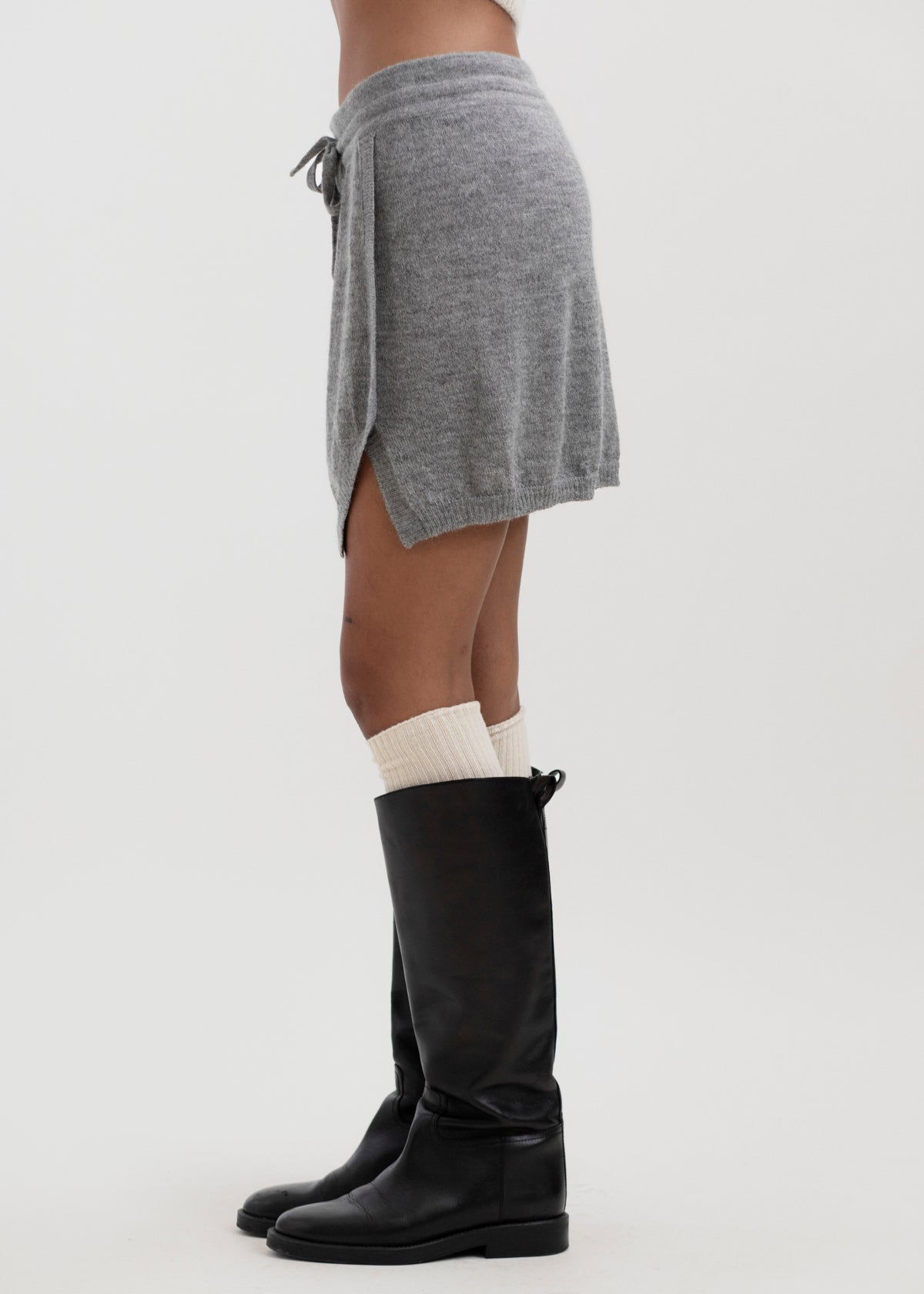 Lisa Mini Skirt in Mist Grey, baby alpaca jersey mini skirt by Ahblo, worn by model