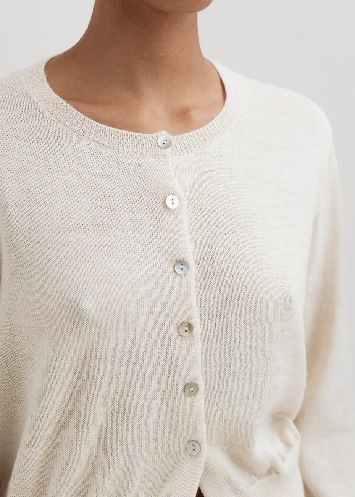 Lulu Cardigan in Cream, alpaca cardigan by Ahblo, worn by model