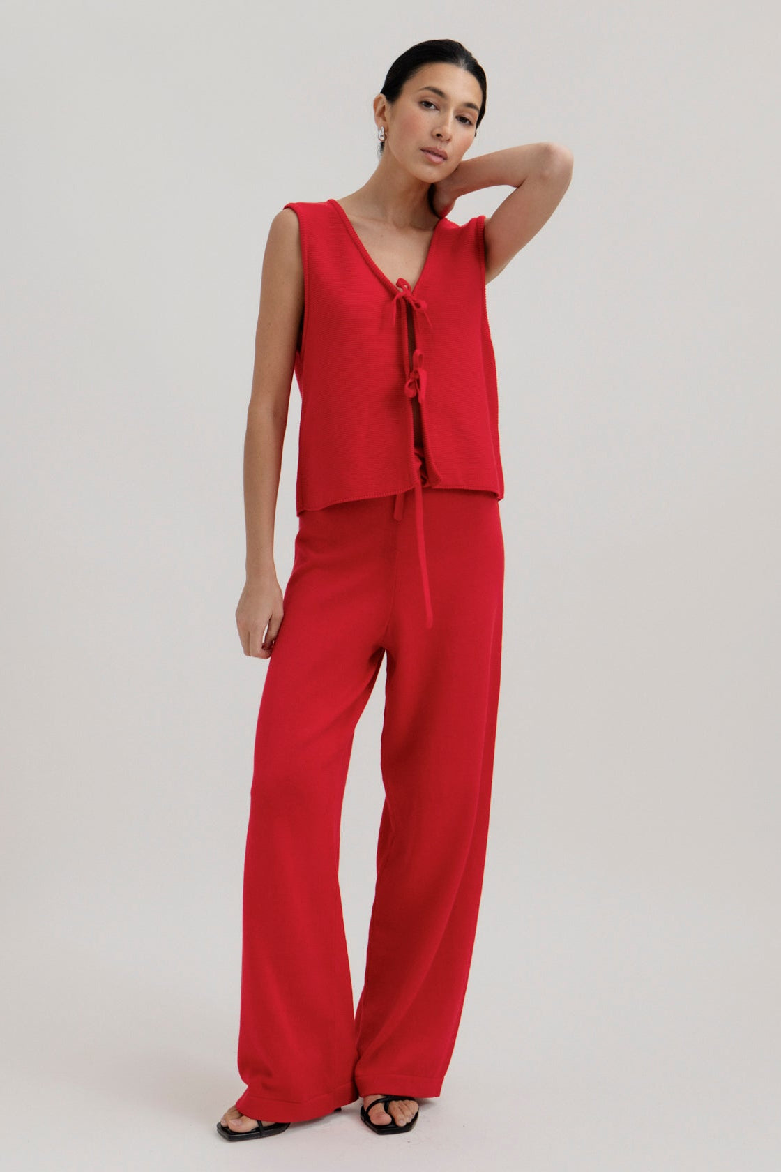 Luzia Vest and Alba Pants in Cerise, cotton and baby alpaca knitwear by Ahblo, worn by model
