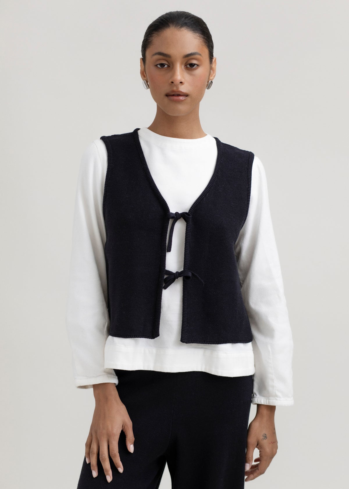 Luzia Vest in Black, cotton and baby alpaca knit vest by Ahblo, worn by model