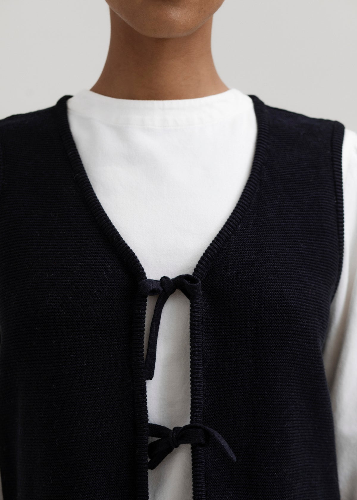 Luzia Vest in Black, cotton and baby alpaca knit vest by Ahblo, worn by model