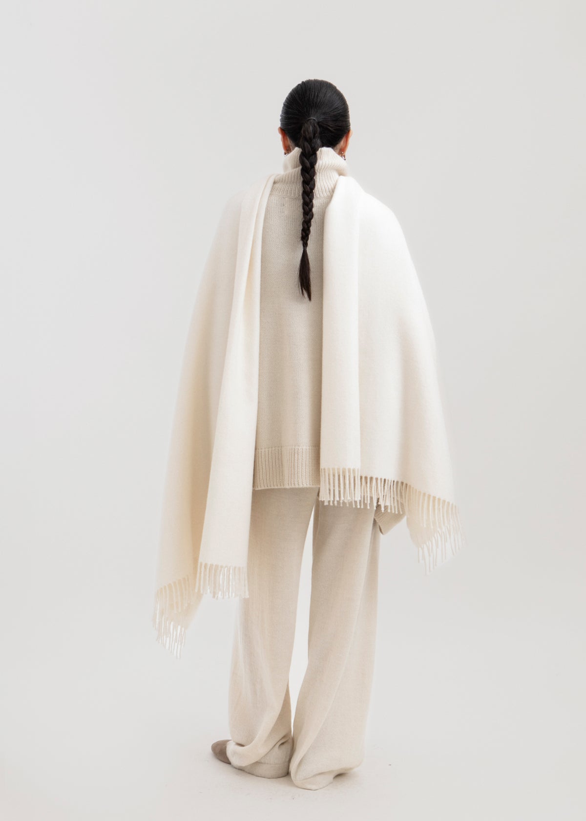 Riley Scarf in Cream, blanket-size baby alpaca scarf by Ahblo, worn by model