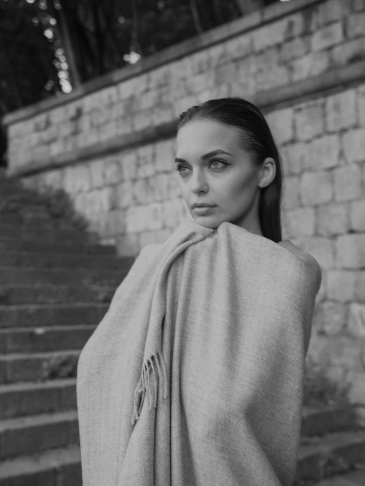 Riley Scarf in Mist Grey, blanket-size baby alpaca scarf by Ahblo, worn by model