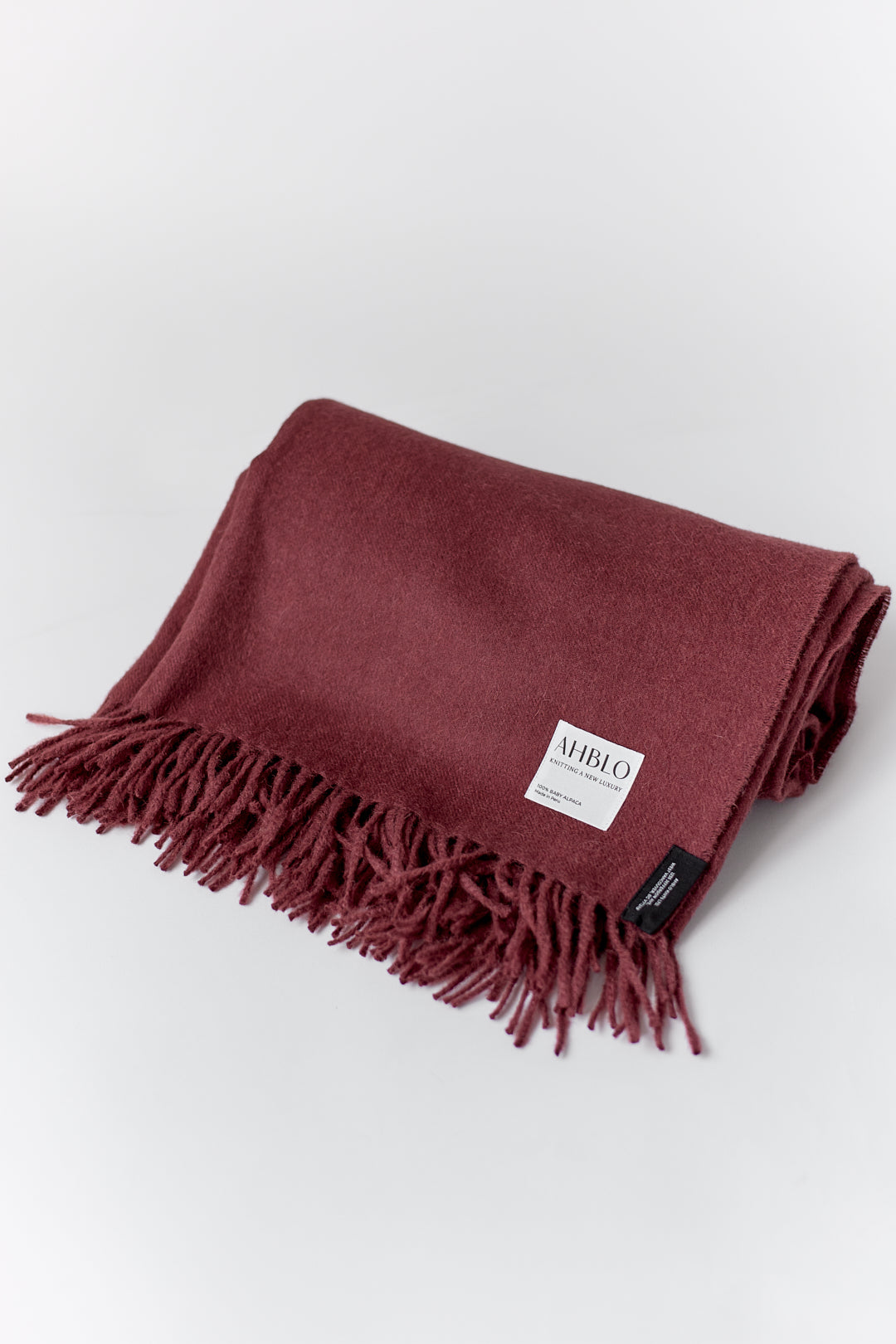 Rowan Scarf in Burgundy, fringed baby alpaca scarf by Ahblo, flat lay