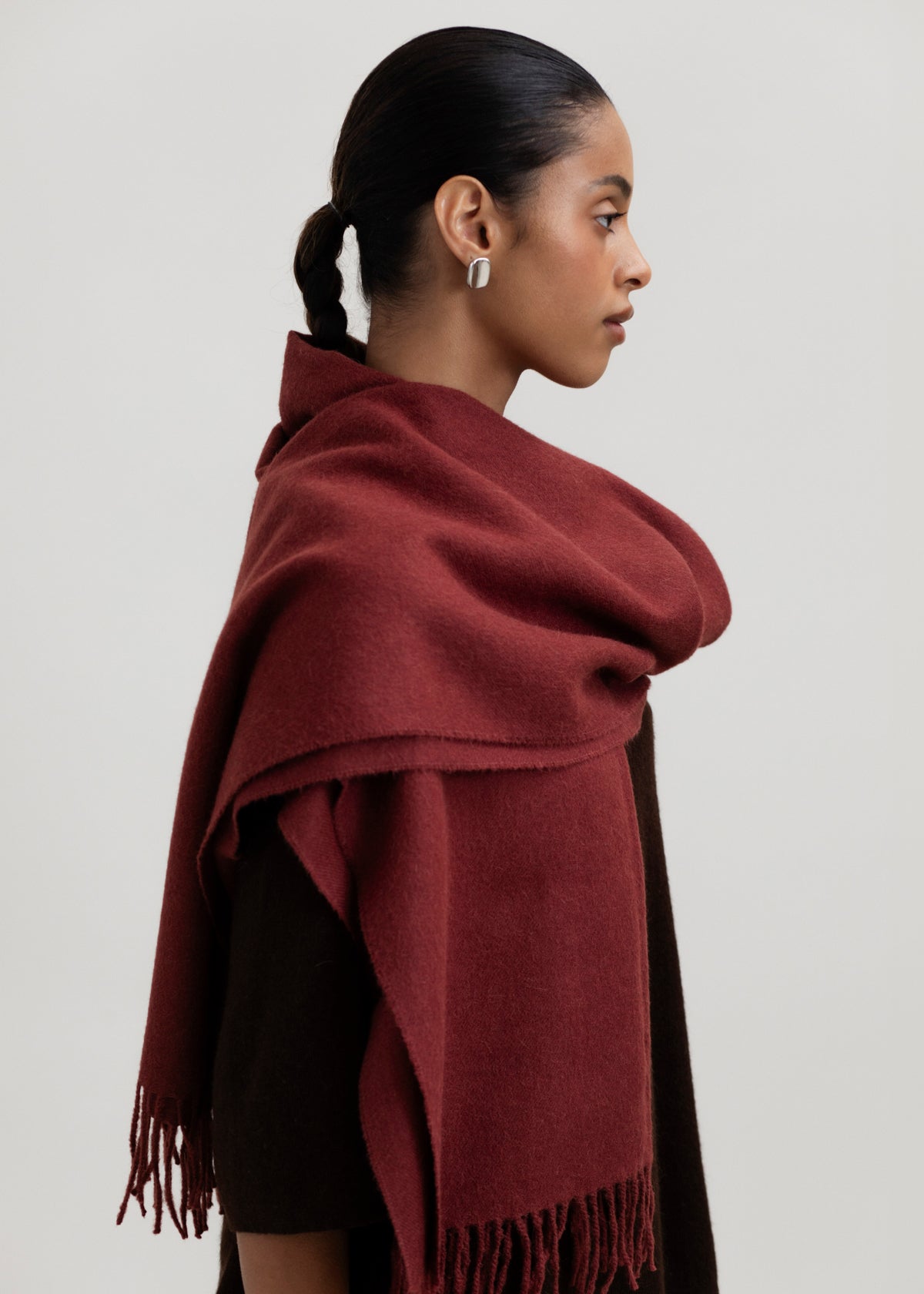 Rowan Scarf in Burgundy, fringed baby alpaca scarf by Ahblo, worn by model