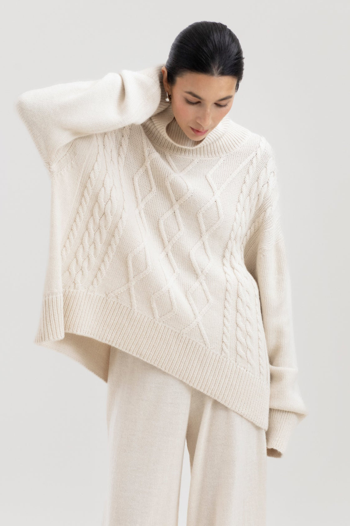 Sierra Cable Knit in Cream, oversized baby alpaca cable-knit sweater by Ahblo, worn by model