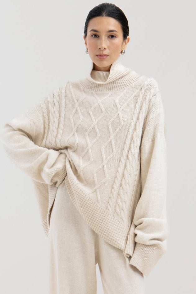 Sierra Cable Knit in Cream, oversized baby alpaca cable-knit sweater by Ahblo, worn by model