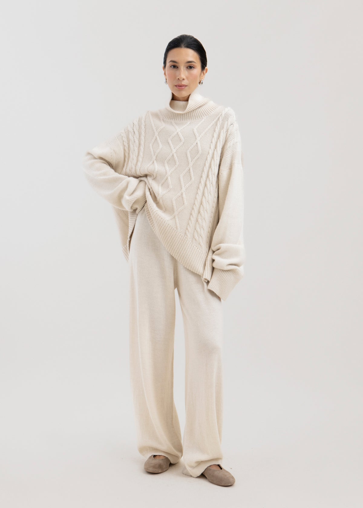 Sierra Cable Knit in Cream, oversized baby alpaca cable-knit sweater by Ahblo, worn by model