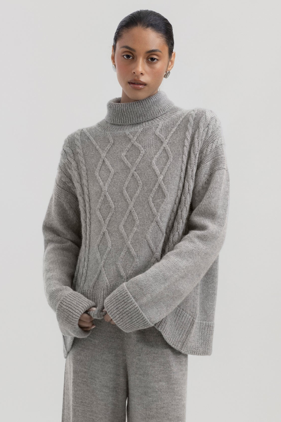Sierra Cable Knit in Mist Grey, oversized baby alpaca cable-knit sweater by Ahblo, worn by model