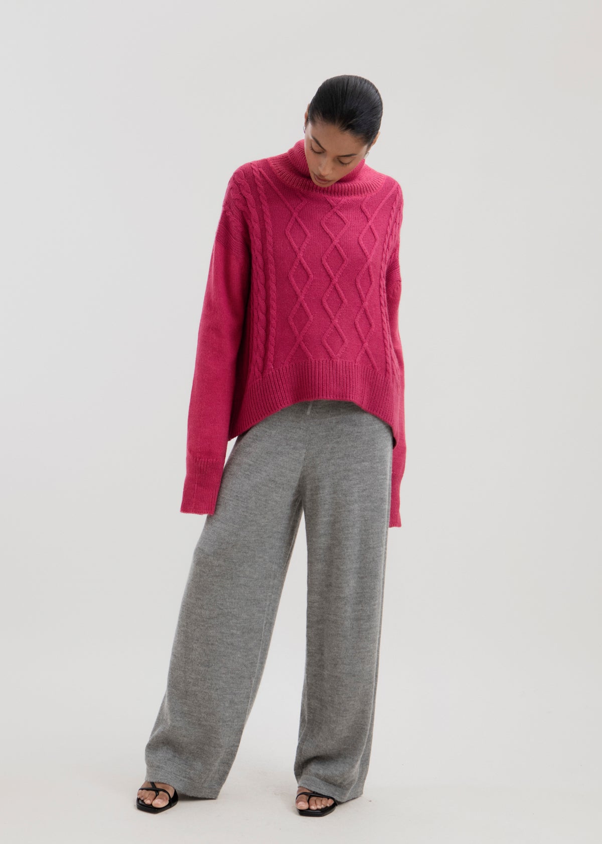 Sierra Cable Knit in Wild Pink, oversized baby alpaca cable-knit sweater by Ahblo, worn by model