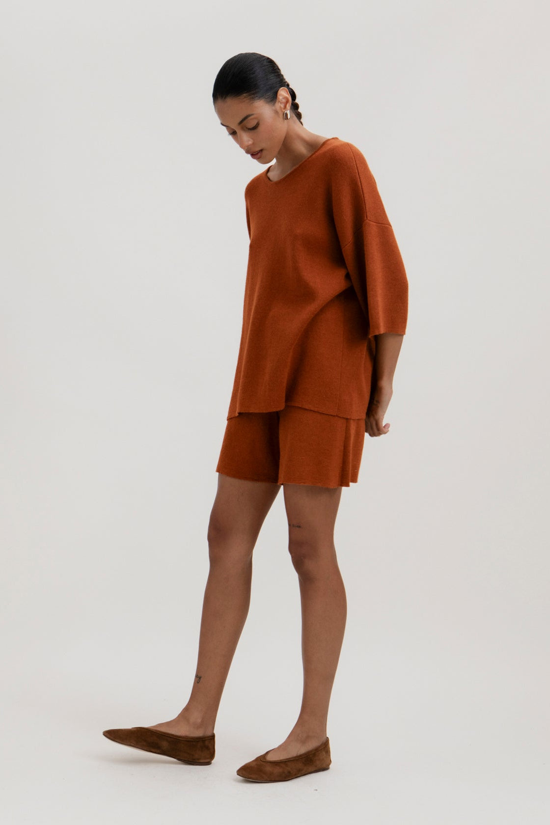 Solace Tee Sweater and Airy Shorts in Burnt Orange, alpaca and silk knitwear by Ahblo, worn by model
