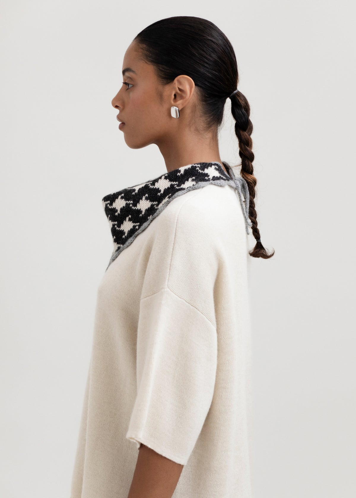 Tessa Scarf in Grey, reversible houndstooth baby alpaca triangle scarf by Ahblo, worn by model