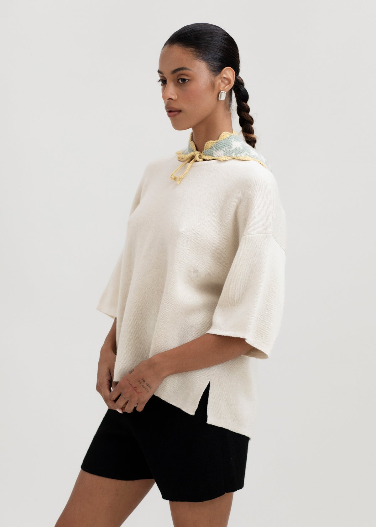 Tessa Scarf in Sage, reversible houndstooth baby alpaca triangle scarf by Ahblo, worn by model