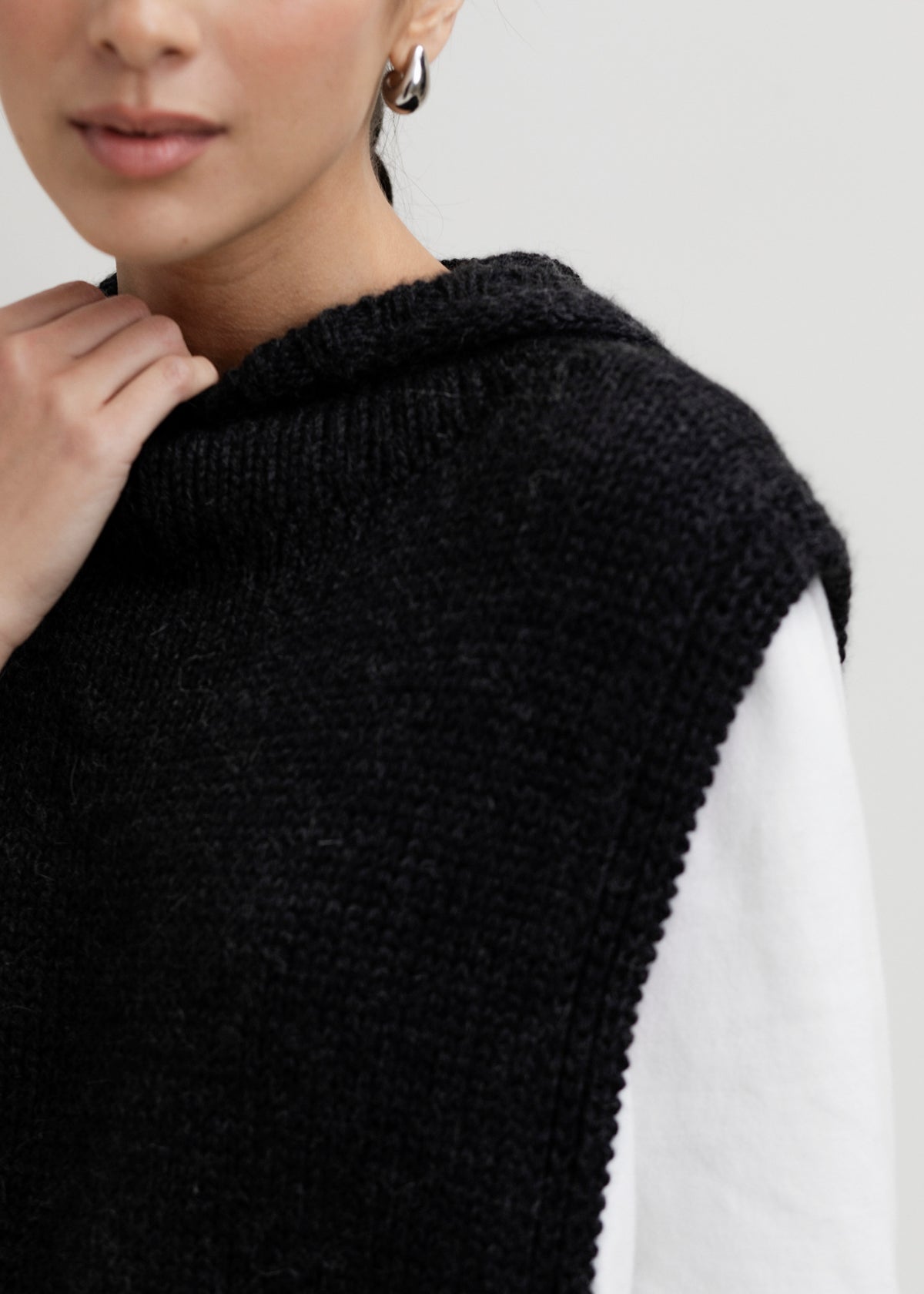 Tofino Poncho in Charcoal, baby alpaca mini poncho by Ahblo, worn by model