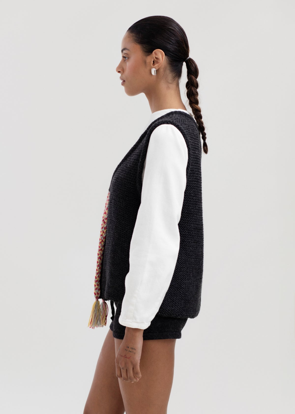 Vela Braid Vest in Charcoal, baby alpaca knit vest with hand-braided trim by Ahblo, worn by model