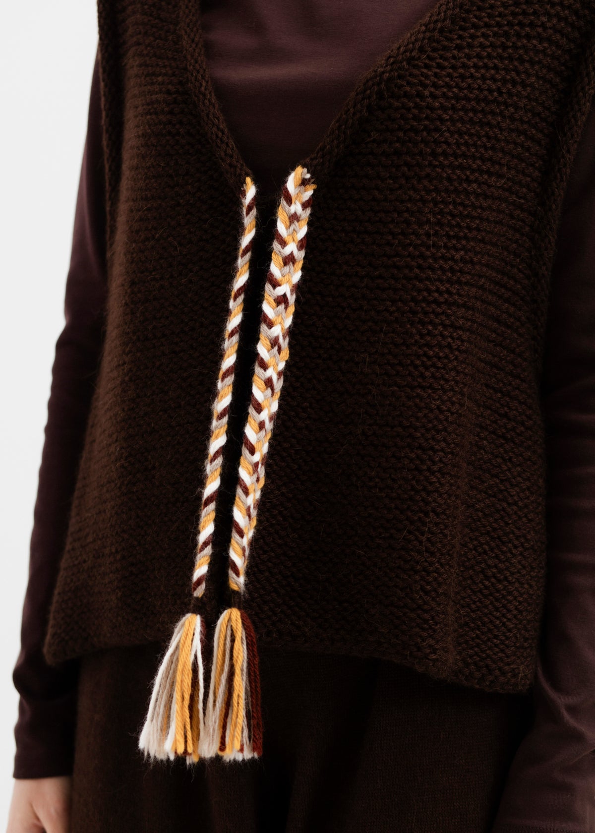 Vela Braid Vest in Chocolate Brown, baby alpaca knit vest with hand-braided trim by Ahblo, worn by model