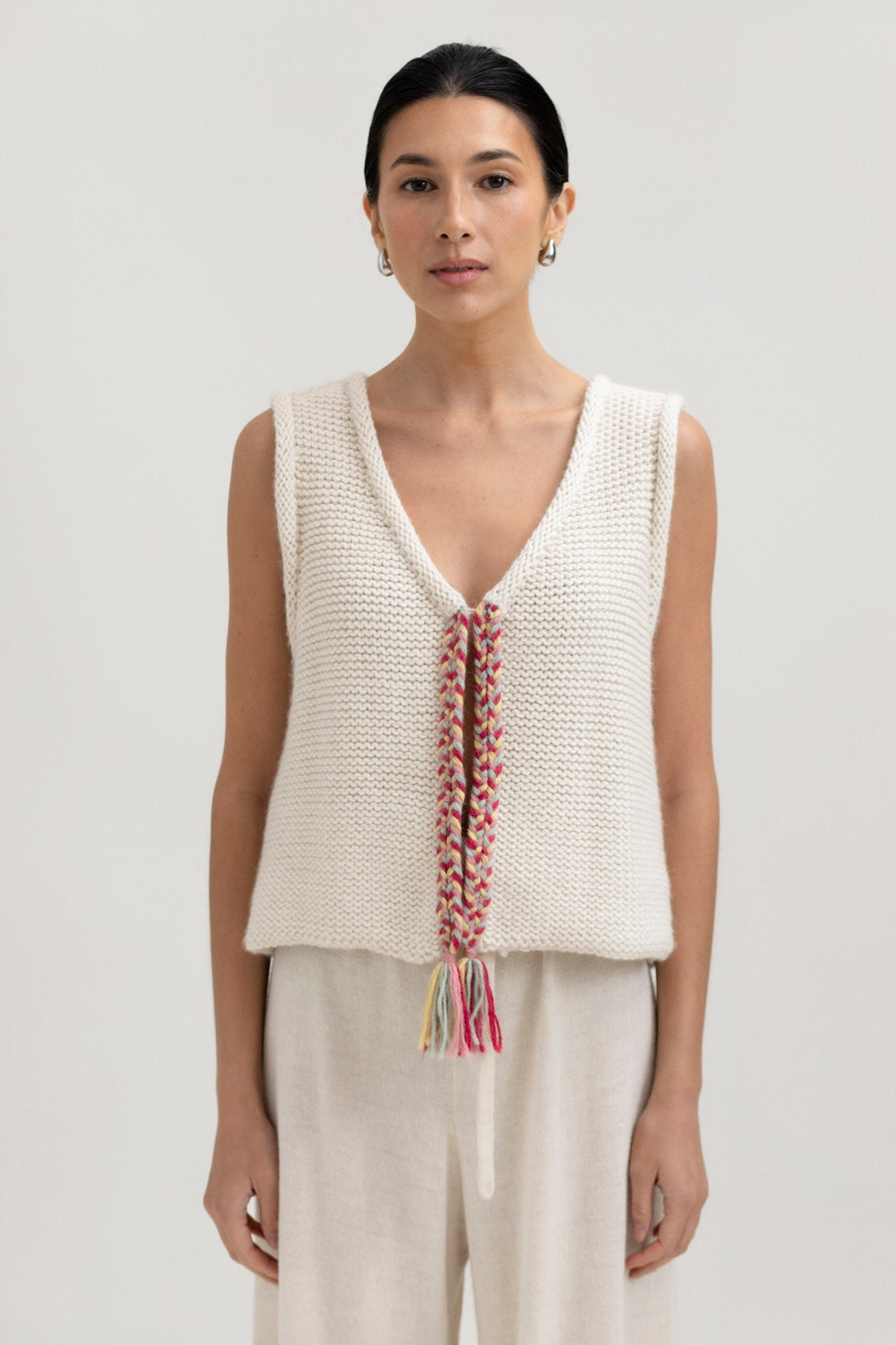 Vela Braid Vest in Cream, baby alpaca knit vest with hand-braided trim by Ahblo, worn by model