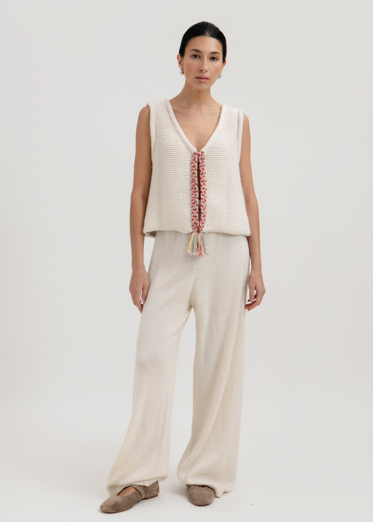 Vela Braid Vest in Cream, baby alpaca knit vest with hand-braided trim by Ahblo, worn by model