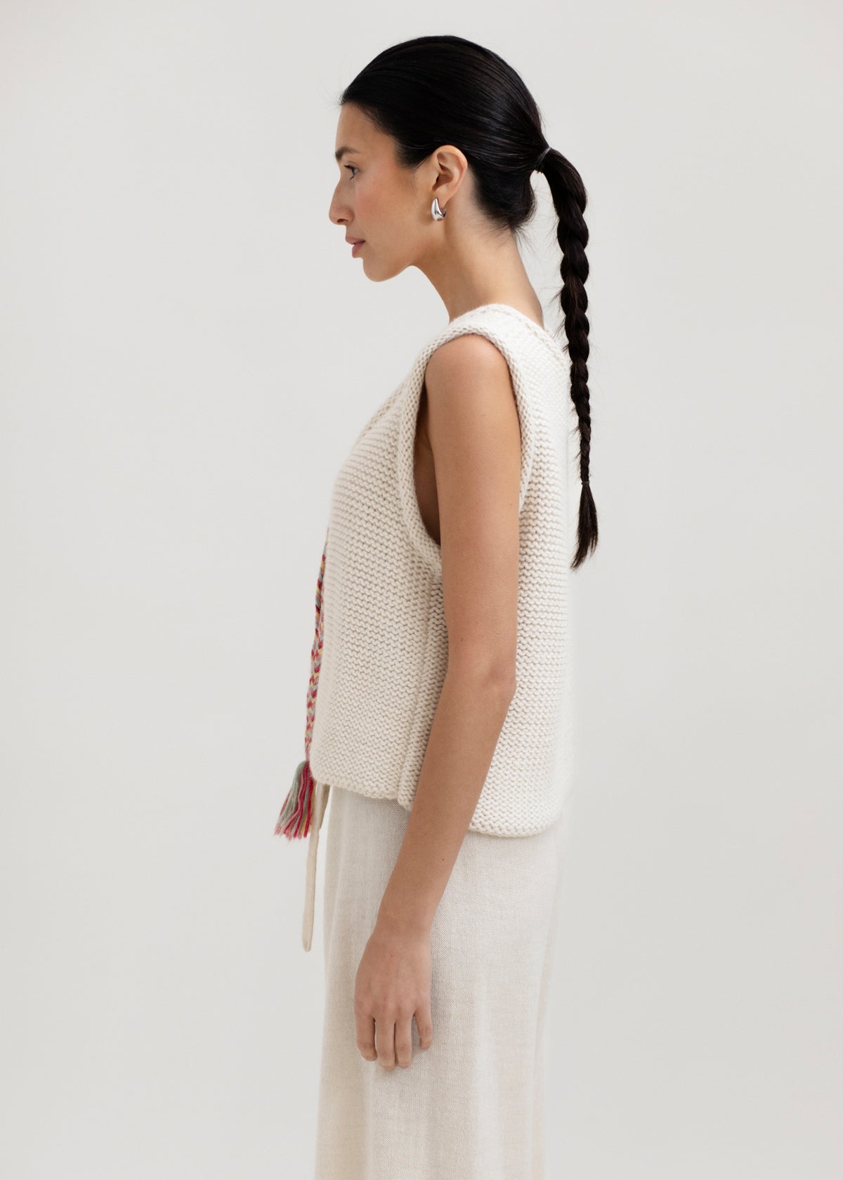 Vela Braid Vest in Cream, baby alpaca knit vest with hand-braided trim by Ahblo, worn by model