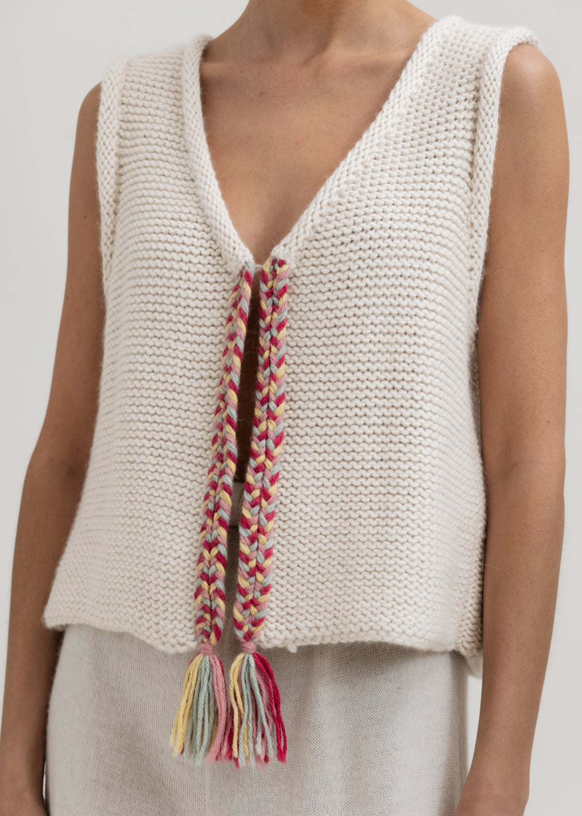 Vela Braid Vest in Cream, baby alpaca knit vest with hand-braided trim by Ahblo, worn by model